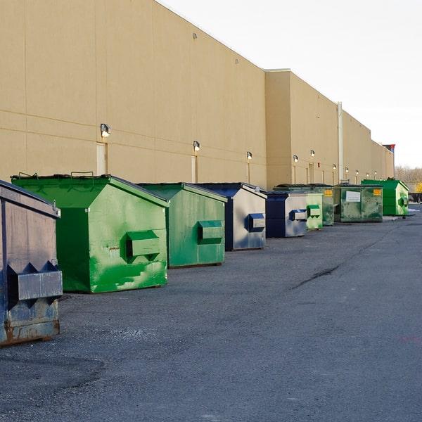 a commercial waste container parked in a city alley